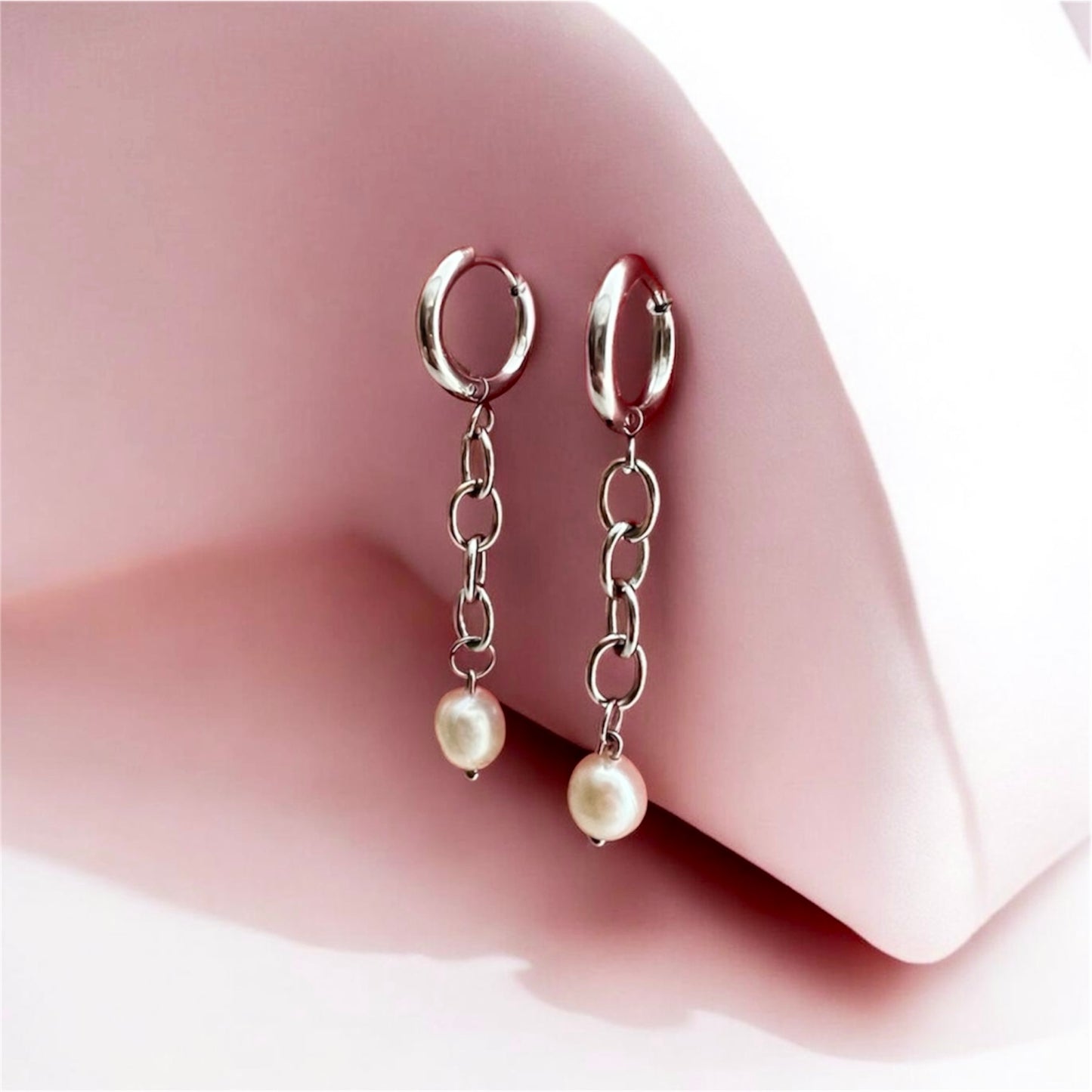 Monique - chunky silver chain earrings, side angle, pink background