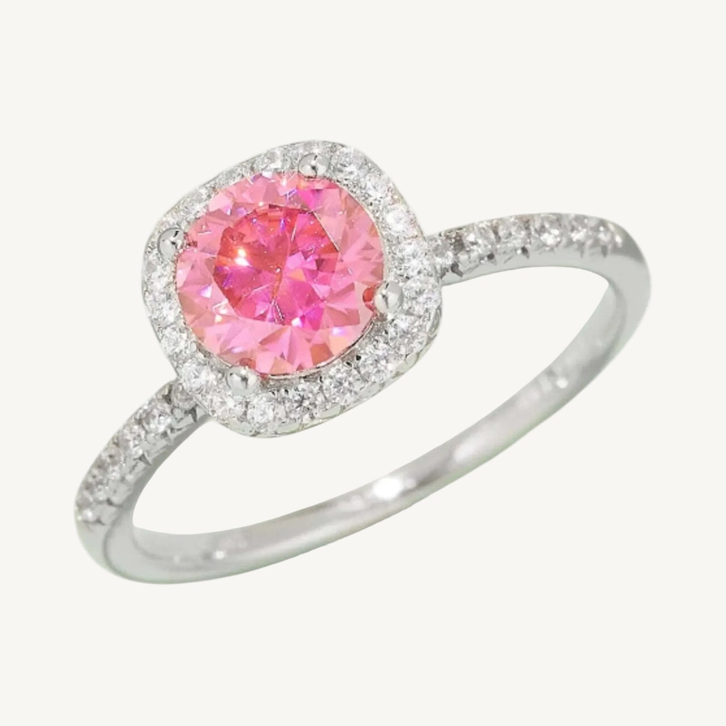 1 carat pink Moissanite halo ring with silver band on a white background close up 