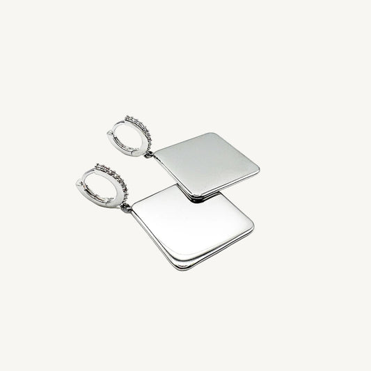 Pair of silver square earrings on a white background